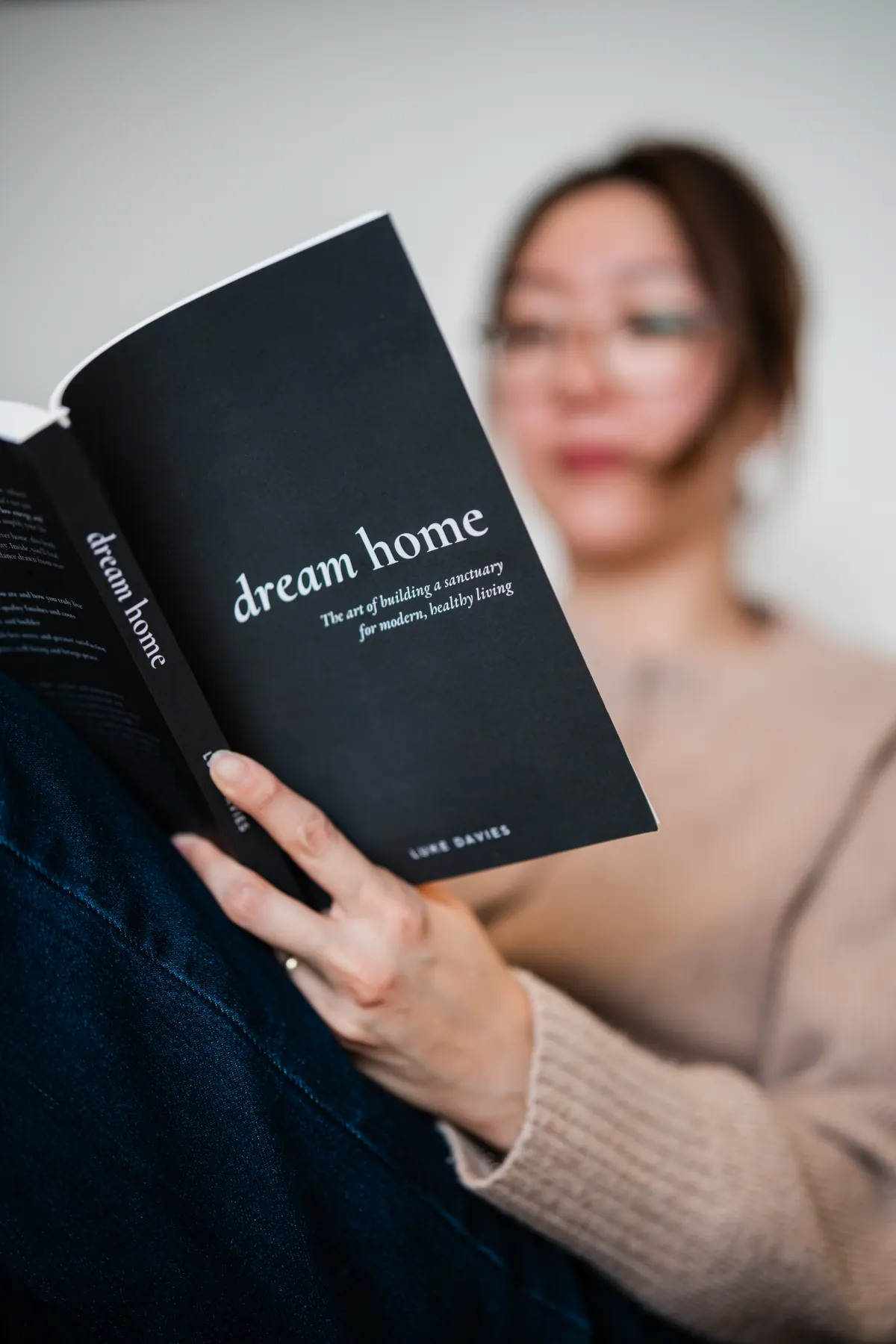 Close view of the Dream Home cover held open by a reader